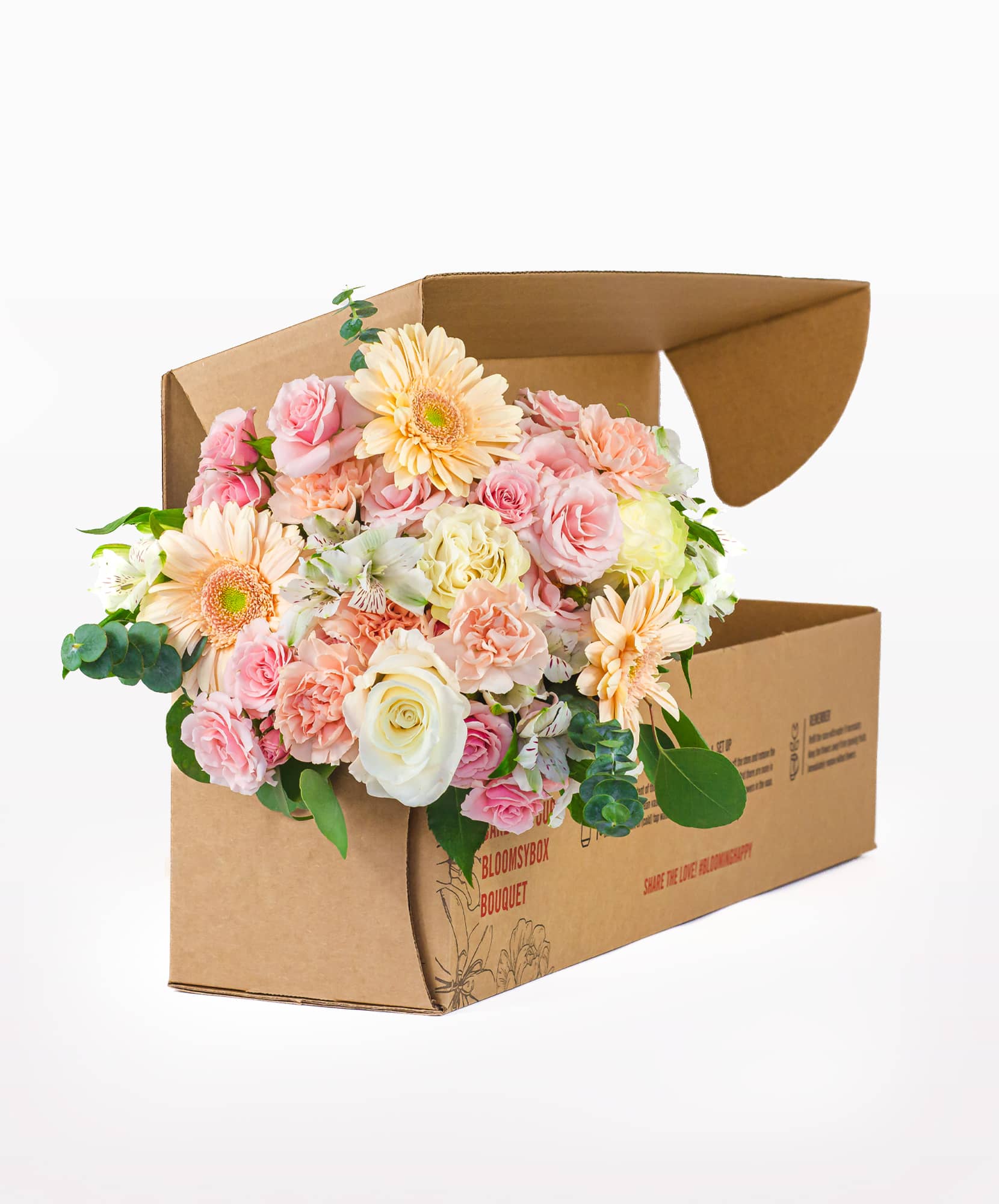 Beautiful bouquet featuring pastel roses, gerbera daisies, and greenery, presented in a stylish box.